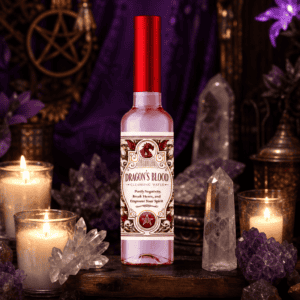 Dragon's Blood cleansing water bottle on a wooden altar with candles and crystals
