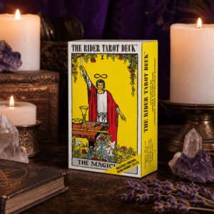 The Rider Tarot Deck box on a wooden altar with candles and crystals